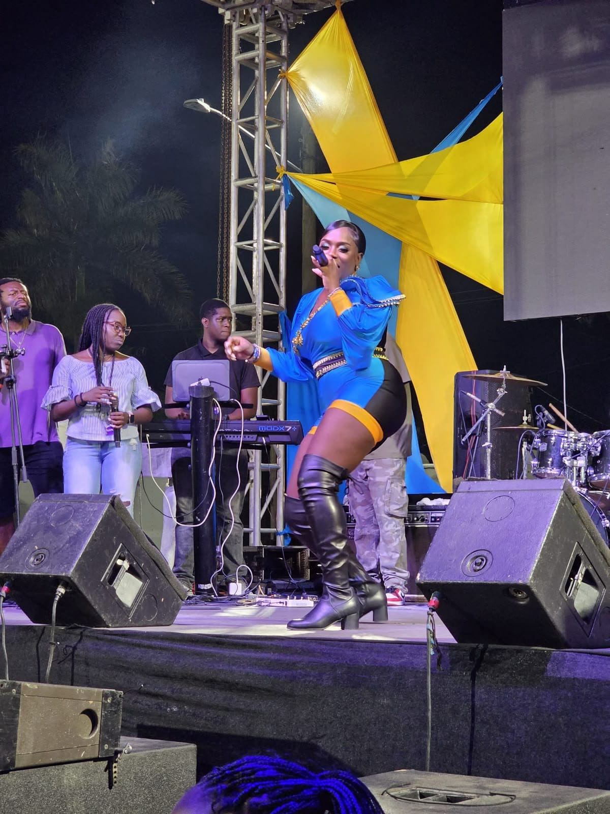 Mama D on stage at the Grand Bahama Cultural Festival with the Bahamian star backdrop